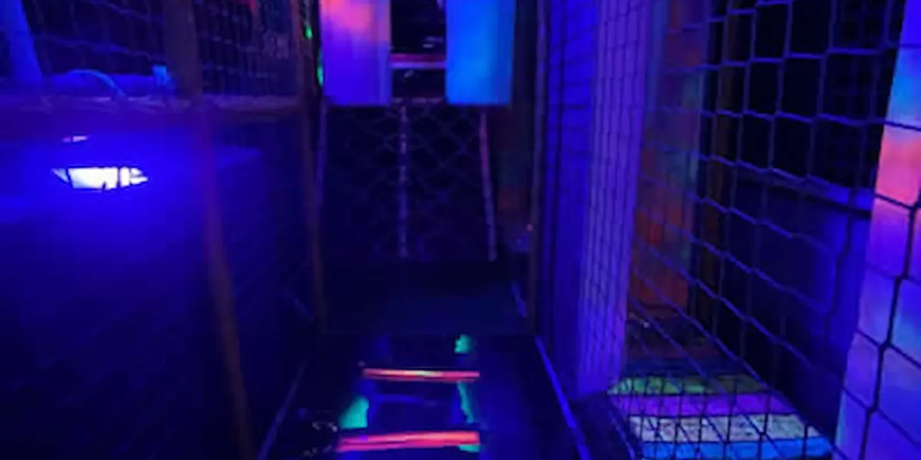 Children’s soft play climbing tunnel and walkway inside the Essex Soft Play Bus with colourful LED lighting and indoor play equipment.