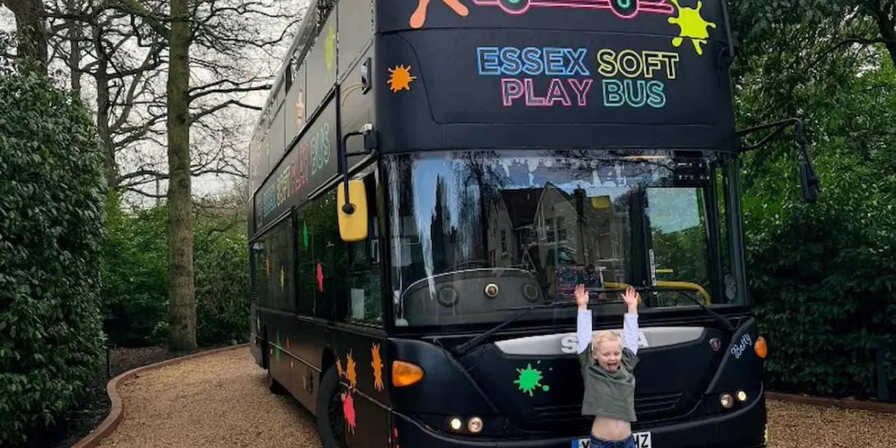 The Essex Soft Play Bus double decker soft play party bus with colourful branding parked at a children's birthday party in Essex