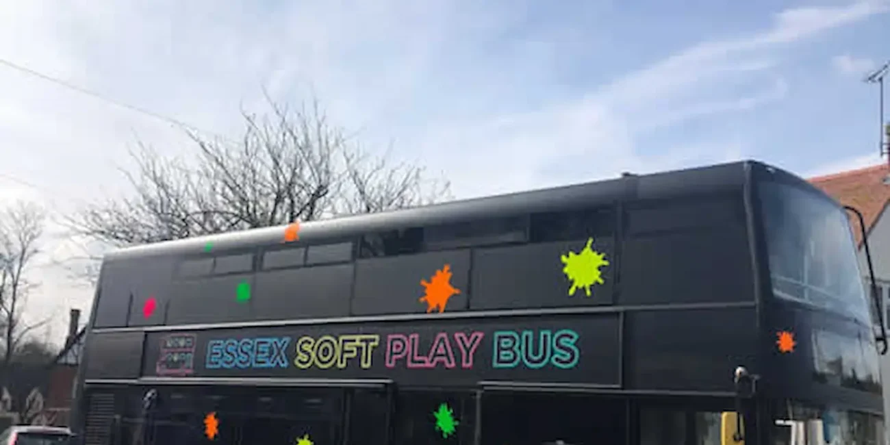 The Essex Soft Play Bus double decker children's soft play party bus parked outside a venue in Essex