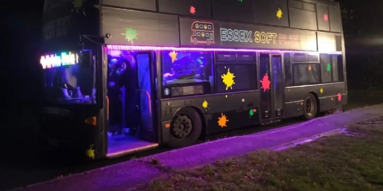 The Essex Soft Play Bus illuminated at night ready for a children's birthday party in Essex