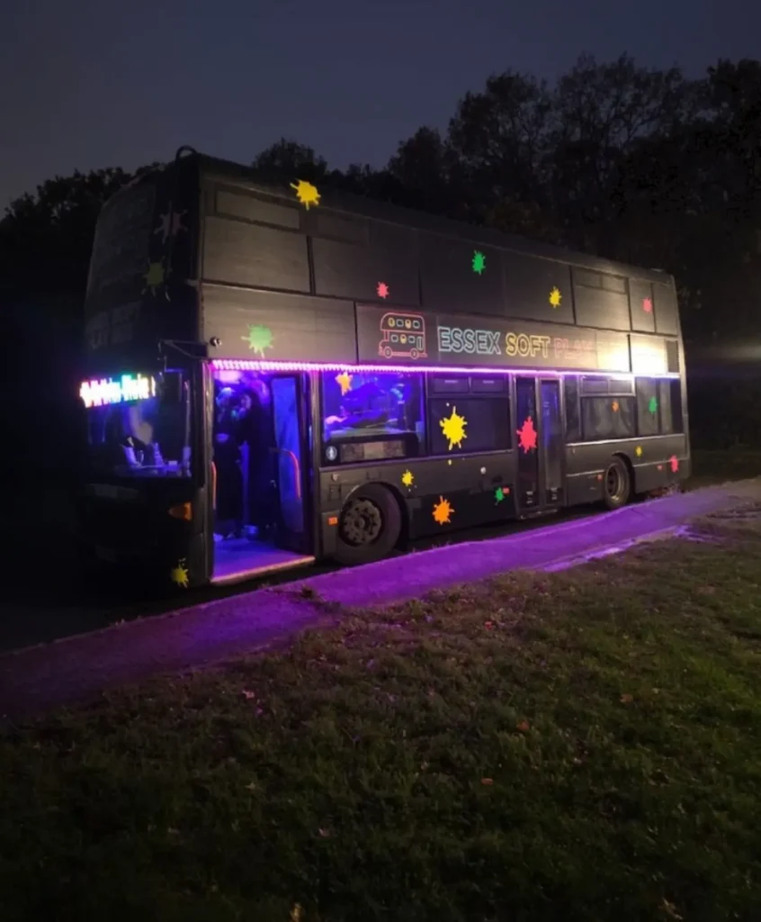 The Essex Soft Play Bus illuminated at night ready for a children's birthday party in Essex