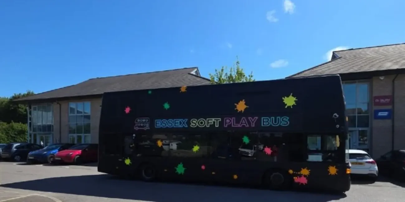 The Essex Soft Play Bus double decker soft play party bus parked outside a children's party venue in Essex