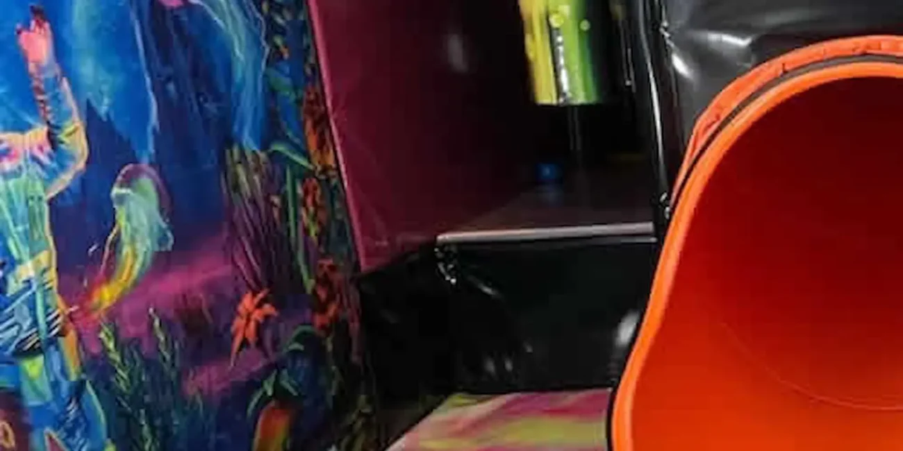 Children’s slide and ball pit inside the Essex Soft Play Bus with colourful themed play area and soft play equipment.
